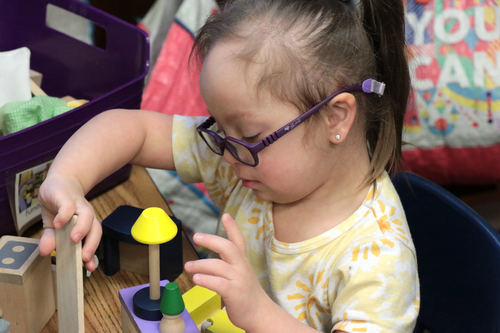 A student plays with blocks